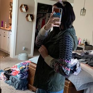 Green jacket with sweater sleeves.